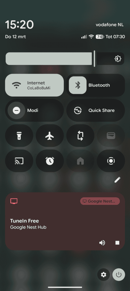 Scherm met snelle Android-instellingen met Wi-Fi, Bluetooth en andere besturingselementen. Een melding onderaan laat zien dat TuneIn Free wordt afgespeeld op Google Nest Hub. Tijd is 15:20, opgenomen tijdens een Google Pixel 10a review.